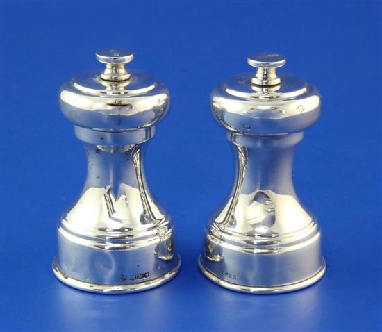 A pair of 1930s silver pepper mills by William Hutton & Sons Ltd, 3in.